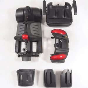Disassembled parts of a BuzzAround EX 4-Wheel Scooter, including a seat, base, front section with wheels, basket, and two side panels, are neatly arranged on a white surface.