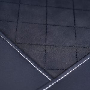 Close-up of the Buzzaround XL+ 4-Wheel Scooter’s dark quilted seat fabric, featuring square patterns and visible white stitching along the edges.