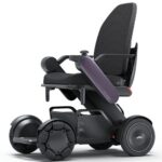 WHILL Model C2 High Back electric wheelchair featuring a mesh backrest, armrests, large wheels, and a sleek side-profile design.