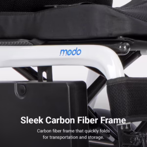 Close-up of the Modo Breeze: a white carbon fiber wheelchair frame with modo label, black seat, and the text Sleek Carbon Fiber Frame at the bottom.