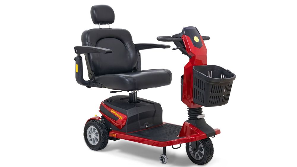 A Companion HD 3-Wheel Scooter in red and black, featuring a padded seat, armrests, headrest, and a front basket.