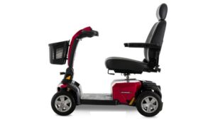 Side view of a red Eagle 4-Wheel Scooter by Golden Technologies, featuring a black seat, armrests, backrest, and a front basket, shown on a white background.