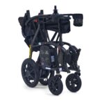 The Golden Cricket LT Side-Folding Carbon Fiber Power Wheelchair features large rear wheels, smaller front wheels, a mesh basket, and a control joystick on the armrest, all in a convenient folded design.