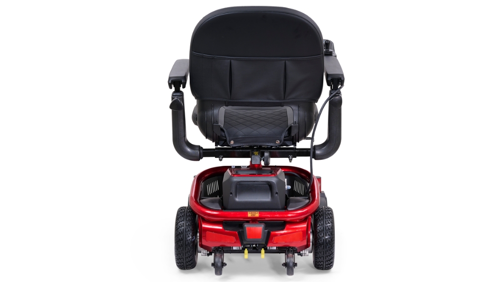 Rear view of a red LiteRider Envy Power Wheelchair with a black cushioned seat, armrests, and four wheels visible.