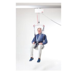 An older adult uses the Evo Hygiene Lowback ceiling-mounted patient lift, suspended in a harness against a plain white background.