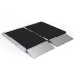 The SUITCASE Singlefold AS Portable Aluminum Wheelchair Ramp (OPEN BOX) features a non-slip black surface, raised side edges, and lightweight aluminum construction, shown here fully extended for easy wheelchair access.