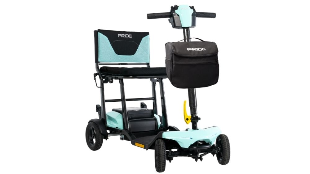 The Go Go Super Portable 4-Wheel Scooter features a compact design, four wheels, a black and teal seat, matching handlebars, and a convenient black storage bag attached to the front.
