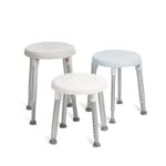 Three Etac Easy Shower Stools in white and light blue, featuring round plastic seats, adjustable metal legs, and rubber feet, are displayed on a white background.