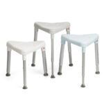 Three Etac Edge Shower Stools, each with grey metal legs and rubber tips, are arranged side by side on a white background.