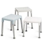 Three Etac Smart Shower Stools with square seats in white and light blue, each featuring an adjustable height, four metal legs, and non-slip rubber feet.