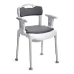 Adjustable white shower chair with gray padded seat and backrest, armrests, and four sturdy legs with rubber feet.