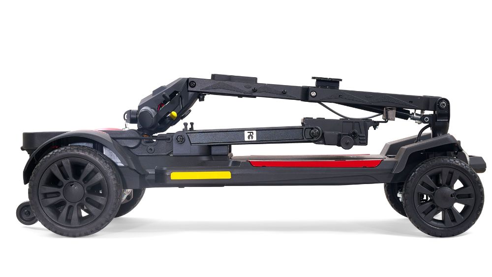 A Buzzaround CarryOn 4-Wheel Scooter in black and red is displayed fully folded and compact, viewed from the side against a white background.