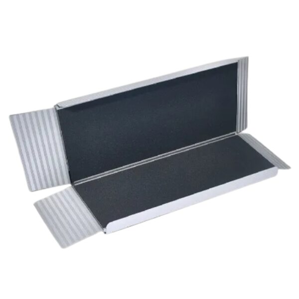 An open rectangular cardboard box with flaps reveals a black Freedom Folding Wheelchair Ramp inside.
