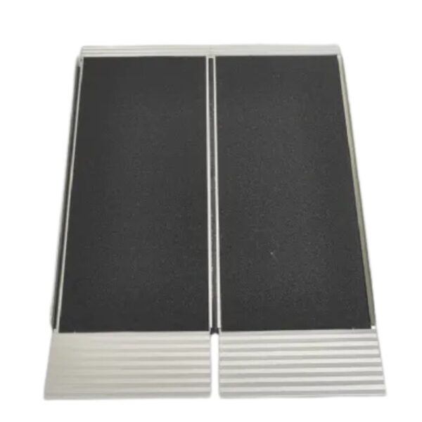 The Freedom Folding Wheelchair Ramp, featuring a textured black surface and silver edges, is displayed fully opened on a white background.
