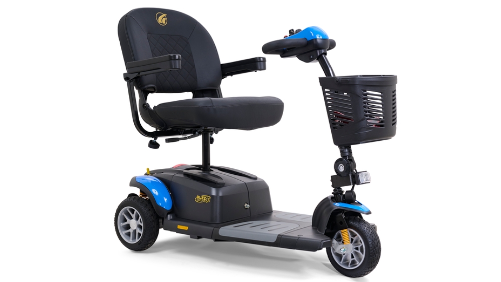 Three-wheel mobility scooter with a black cushioned seat, armrests, a front basket, and blue accents on the wheel covers and handlebar section. The BuzzAround EX 3-Wheel Scooter combines style and comfort for enhanced mobility.