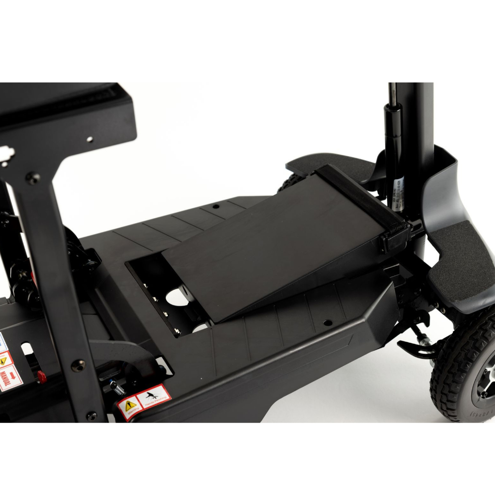 A close-up view of the Monarch Mobility Genie Auto base, showing the platform and battery compartment.