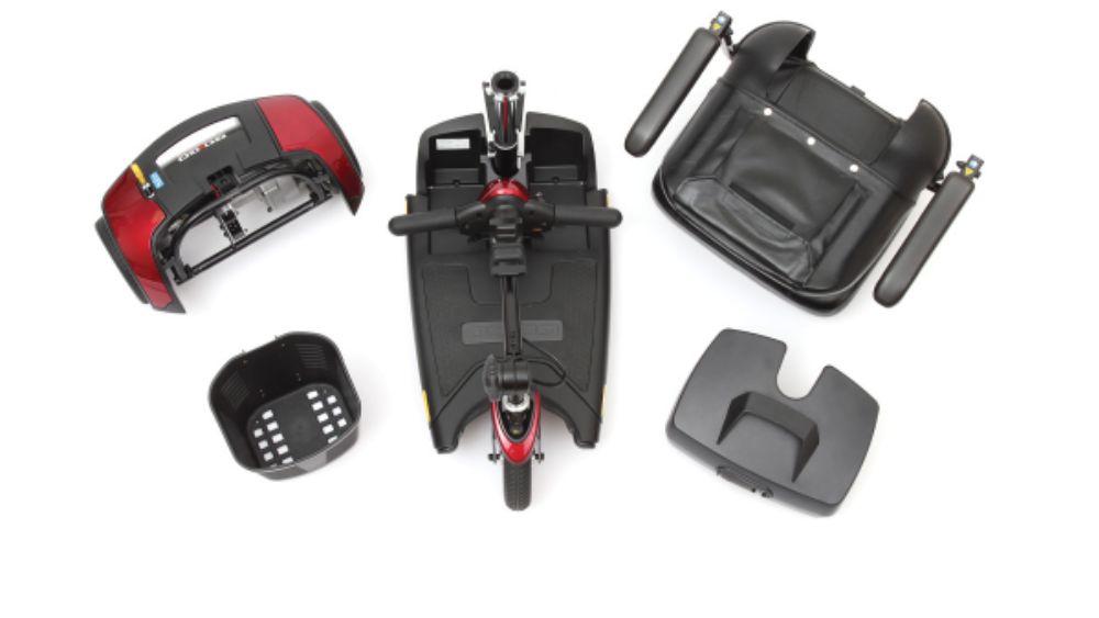 Five components of a disassembled Go Go™ Sport 4-Wheel Scooter are arranged on a white background, including the base, seat, front basket, battery pack, and rear cover.