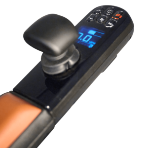 Close-up of the Ally Pro Power Wheelchair electronic control panel with a joystick, blue digital display reading 7.0 MPH, and multiple buttons on a sleek black and orange device.