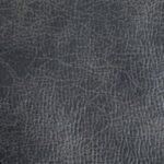 Close-up of the Titan Lift Chairs textured dark gray leather surface, highlighting its natural creases and grain patterns.