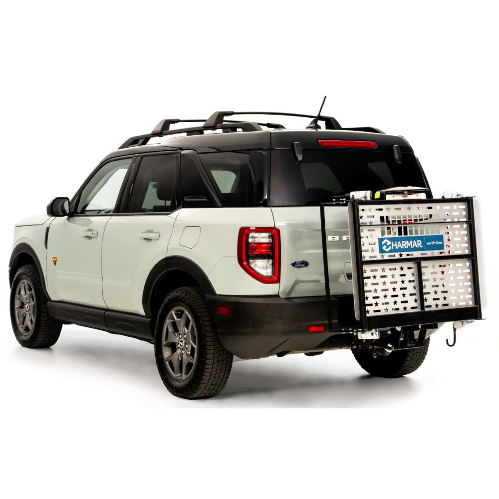 A white SUV with a Harmar Fusion Lift (AL300-MW) mobility lift, featuring a side entry platform, attached to the rear, shown parked on a white background.
