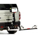 A vehicle equipped with the Harmar Fusion Lift (AL300-MW) attached to the rear bumper, designed for transporting a mobility device such as a wheelchair or scooter. For enhanced accessibility, some models also offer a side entry platform lift for convenient boarding and exiting.