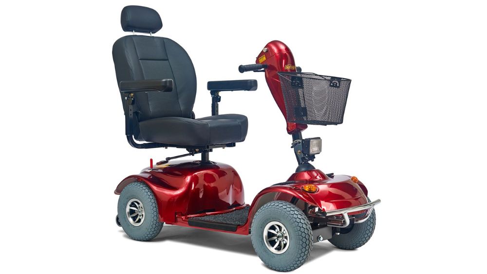 The Avenger 4-Wheel Scooter, shown against a white background, features a red design with a padded seat, armrests, headrest, front basket, and four wheels.
