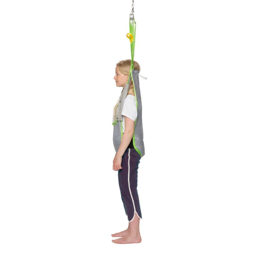 A child stands upright in a Human Care Activity Sling suspended from above, facing sideways, against a white background.