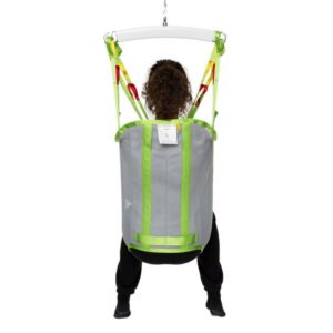 Person sitting in a gray and green Human Care Bath Sling-Polyester Net patient lift sling, lifted by straps attached to an overhead support, facing away from the camera.