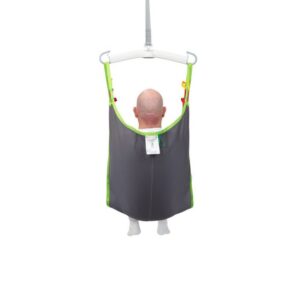 A bald person is seated in a gray and green fabric Human Care Comfort Sling attached to a patient lift, viewed from behind, against a white background.