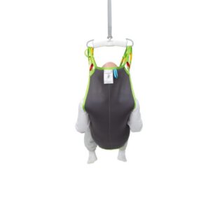 A person sits in a gray and green Human Care Silhouette Sling lift with their feet off the ground, viewed from behind, against a plain white background.