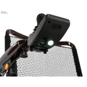 Close-up of a joystick controller with an illuminated light, attached to the Jazzy Carbon 27 Power Wheelchair, which features a mesh backrest.