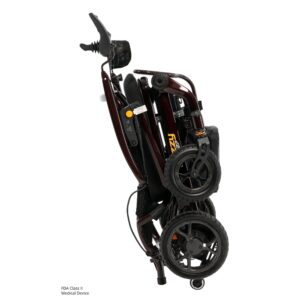 The Jazzy Carbon 27 Power Wheelchair is a compact, foldable electric wheelchair that stands upright with closely aligned wheels and securely collapsed components.