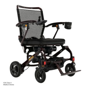 The Jazzy Carbon 27 Power Wheelchair is lightweight and foldable, featuring a mesh backrest, cushioned seat, storage pouch, cup holder, and footrest.