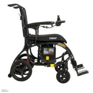 Side view of a black Jazzy Carbon 27X Power Wheelchair with joystick control on the armrest, labeled Jazzy Carbon 27X, featuring a visible battery compartment and footrests.