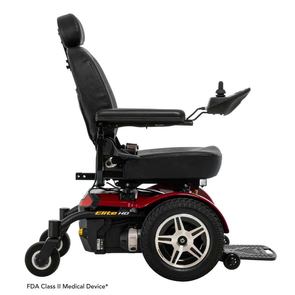 Side view of a Jazzy Elite HD Power Wheelchair featuring a black seat and armrests, red base, large rear wheels, and joystick control mounted on the right armrest. Label below indicates FDA Class II Medical Device.