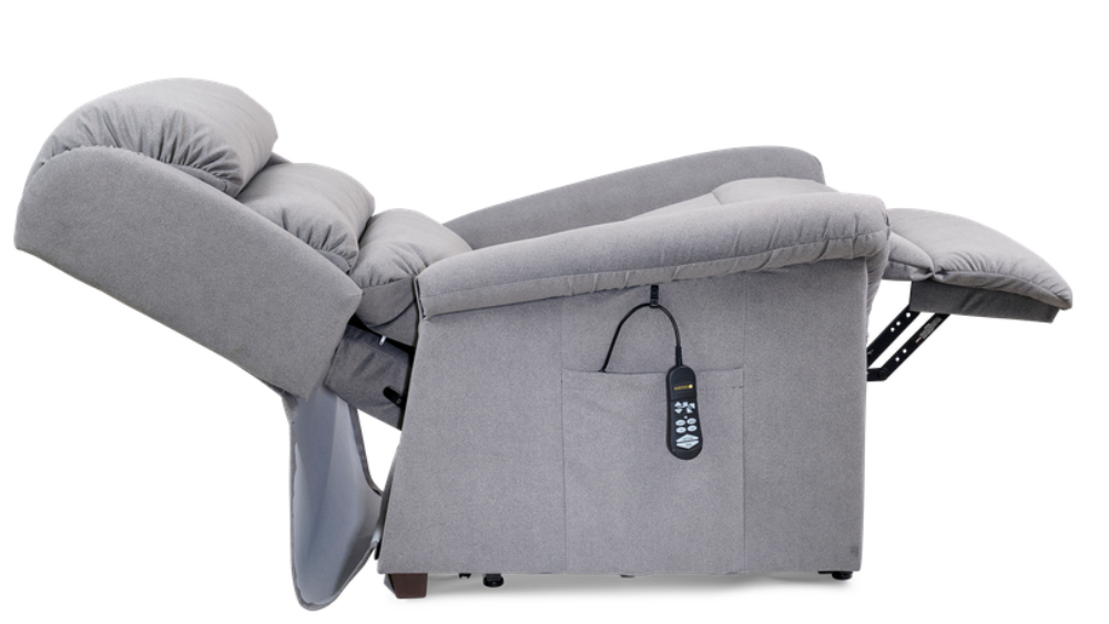 The Relaxer Lift Chair, shown here in grey upholstery and fully reclined, features a remote control conveniently stored in its side pocket.