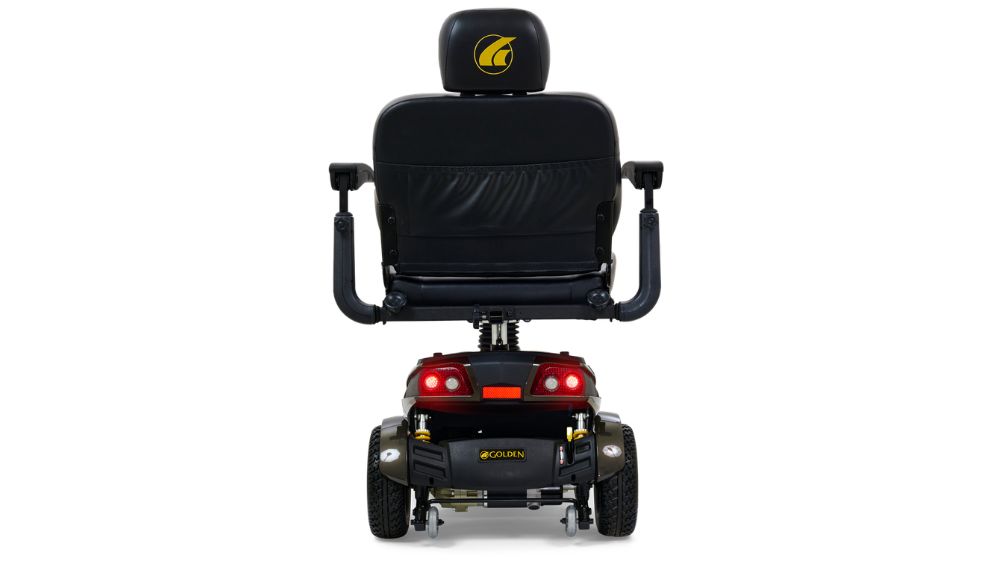 Rear view of a black Companion HD 3-Wheel Scooter featuring armrests, a headrest, rear lights, and visible wheels. The Golden logo is printed on the back of the seat and the scooter’s base.