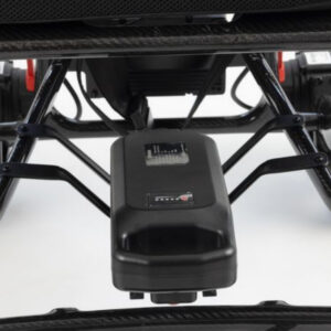 Black Monarch Mobility MM60 Carbon battery pack mounted beneath the frame of a wheelchair.