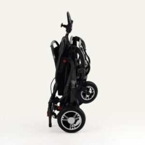 A black Monarch Mobility MM60 Carbon folding power wheelchair in its collapsed, upright position.