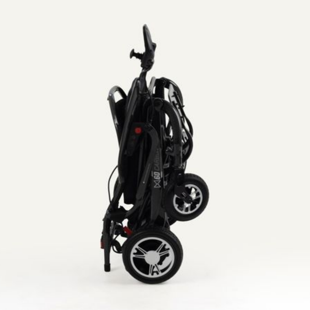 A black Monarch Mobility MM60 Carbon folding power wheelchair in its collapsed, upright position.