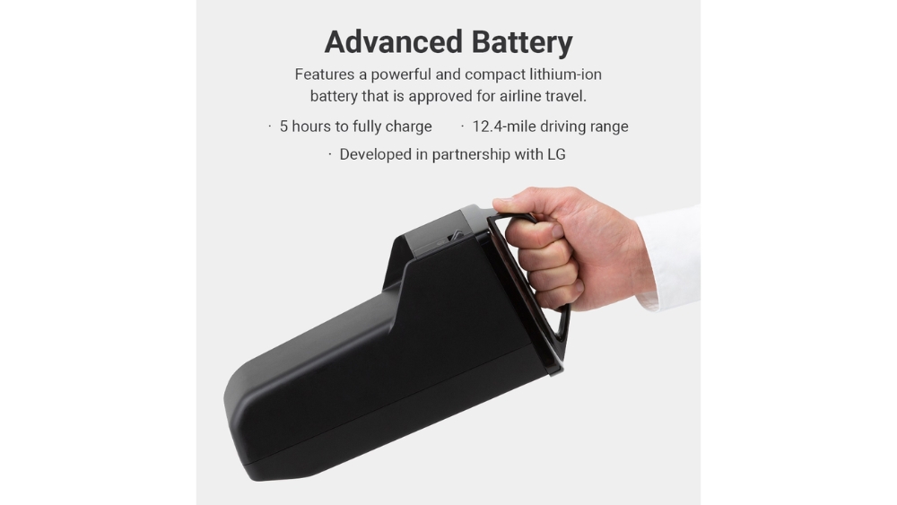 A hand holds a rectangular black WHILL Model F battery against a plain background, with text above highlighting its lithium-ion technology, fast charging time, impressive range, and collaboration with LG.