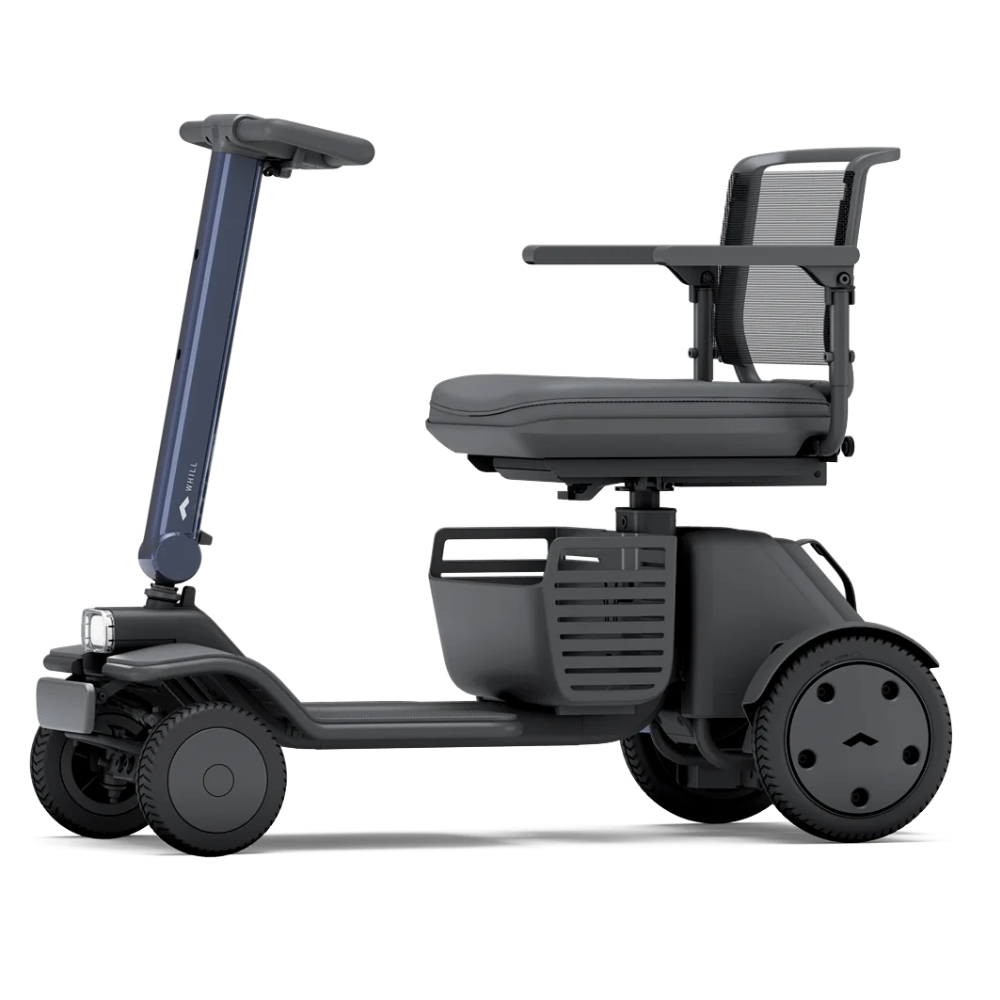 A compact, modern WHILL Model R mobility scooter with three wheels, a mesh backrest, armrests, and a front basket, shown from the side on a white background.