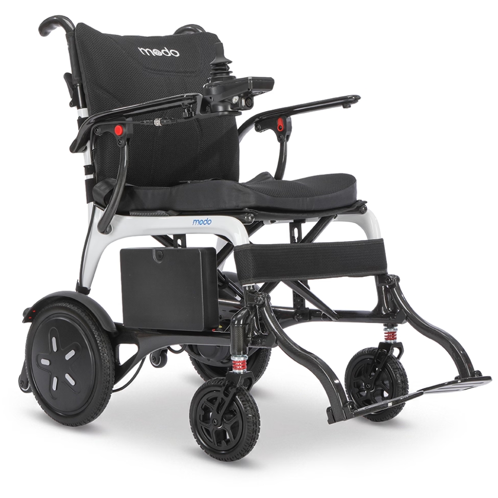 Modo Breeze electric wheelchair with a black seat, padded armrests, joystick control on the right armrest, and large rear wheels. The Modo brand is visible on the headrest.