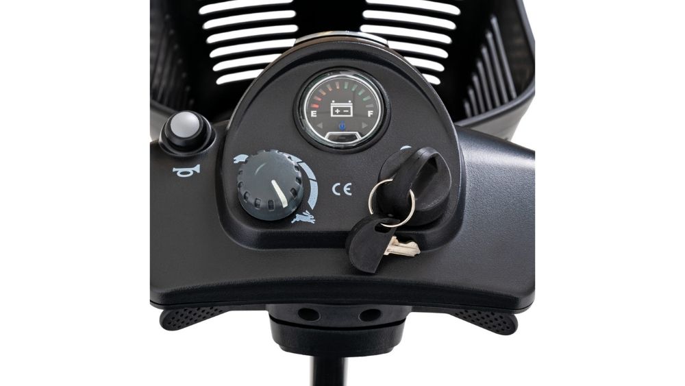 Close-up of the Go Go® Ultra X 3-Wheel Scooter dashboard featuring a speed dial, a key in the ignition, and a charge level indicator.
