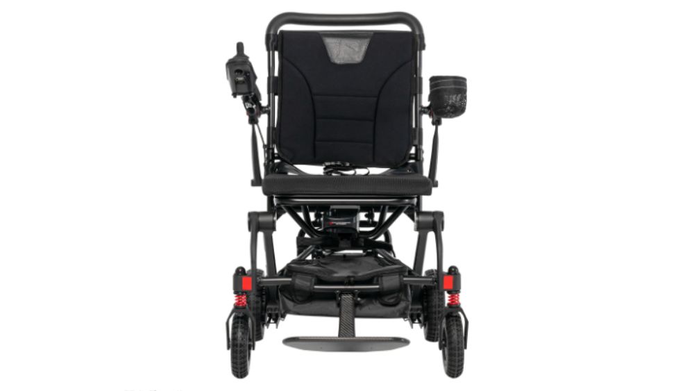 Front view of the Carbon Cruiser Folding Power Wheelchair in black, featuring a joystick control on the left armrest and a cup holder on the right side.