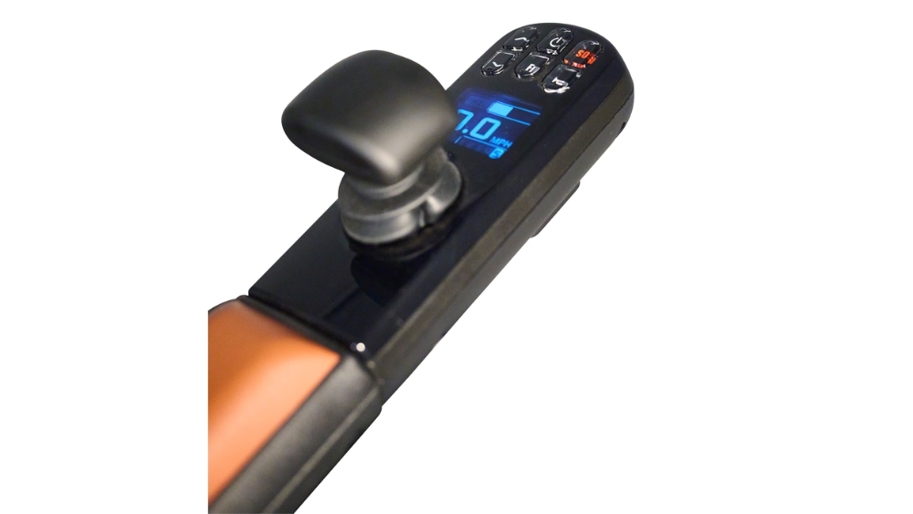 Close-up of the joystick controller on the Ally Pro Power Wheelchair, featuring a display screen that shows speed, settings buttons, and a black joystick handle.