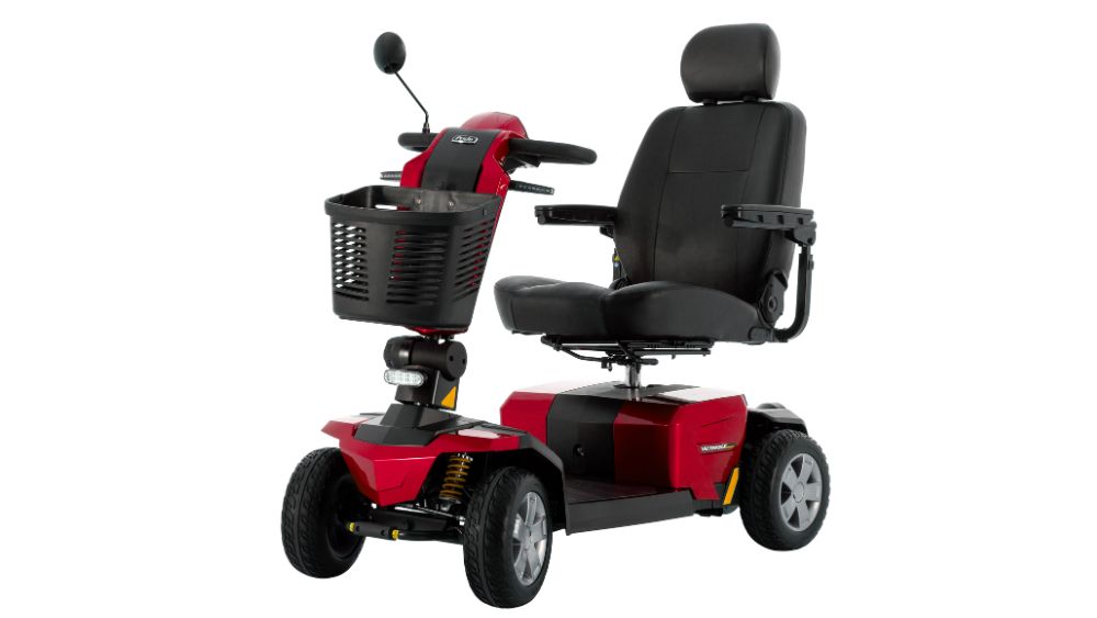 The Victory LX Sport 4-Wheel Scooter is a red and black mobility scooter featuring four wheels, a front basket, a padded seat with armrests, and a headrest, designed for personal transportation.