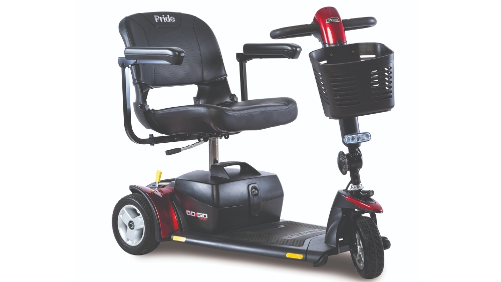 A Go Go™ Sport 3-Wheel Scooter featuring a red body, black seat with armrests, a front basket, and a battery compartment located beneath the seat.
