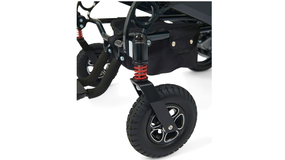 Close-up of a stroller’s front wheel with a visible suspension spring, black frame, and storage basket underneath—offering durability and smooth maneuvering inspired by the Stride Folding Power Wheelchair’s advanced design.