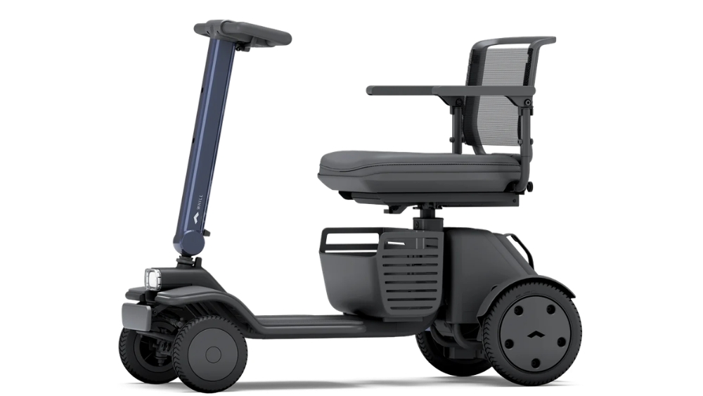 A WHILL Model R, a black and gray three-wheeled mobility scooter featuring a seat, armrests, and upright handlebars, is shown from the side against a white background.
